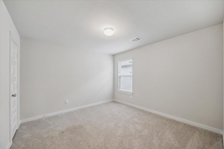 This room is a cozy, carpeted space with neutral walls, featuring a window for natural light and a simple ceiling light fixture. Ideal for a bedroom. This room is a cozy, carpeted space with neutral walls, featuring a window for natural light and a simple ceiling light fixture. Ideal for a bedroom.