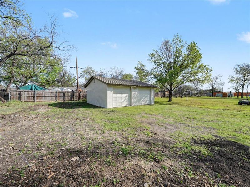 View of yard featuring an outbuilding and a detached garage