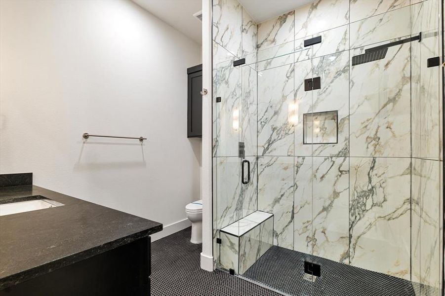 Full bathroom with vanity and a marble finish shower