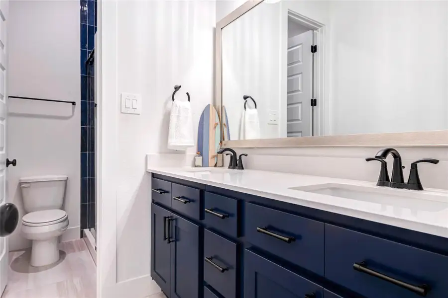 This photo showcases a sleek home gym with dark walls and ceiling, featuring a treadmill, adjustable bench, and dumbbells. A ceiling fan and mirror enhance the modern, functional space. This photo showcases a sleek home gym with dark walls and ceiling, featuring a treadmill, adjustable bench, and dumbbells. A ceiling fan and mirror enhance the modern, functional space.