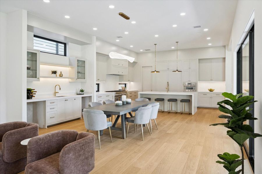 Bright living space with hardwood floors, high-end custom shelving, and wet bar. Bright living space with hardwood floors, high-end custom shelving, and wet bar.