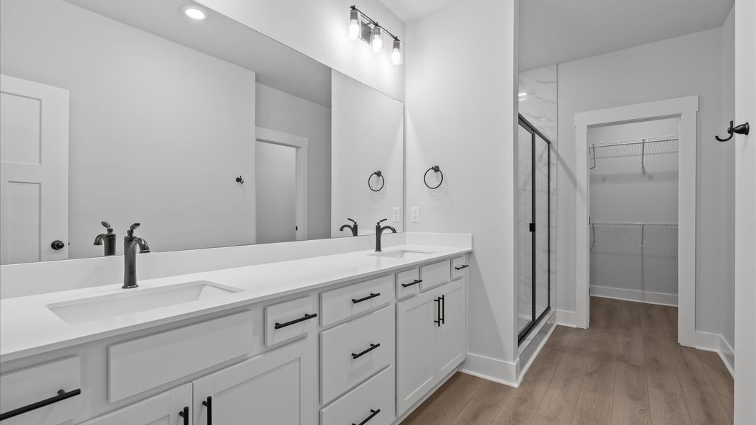 Notable primary suite with dual vanities and tiled walk-in shower in this prime Anderson townhome Notable primary suite with dual vanities and tiled walk-in shower in this prime Anderson townhome