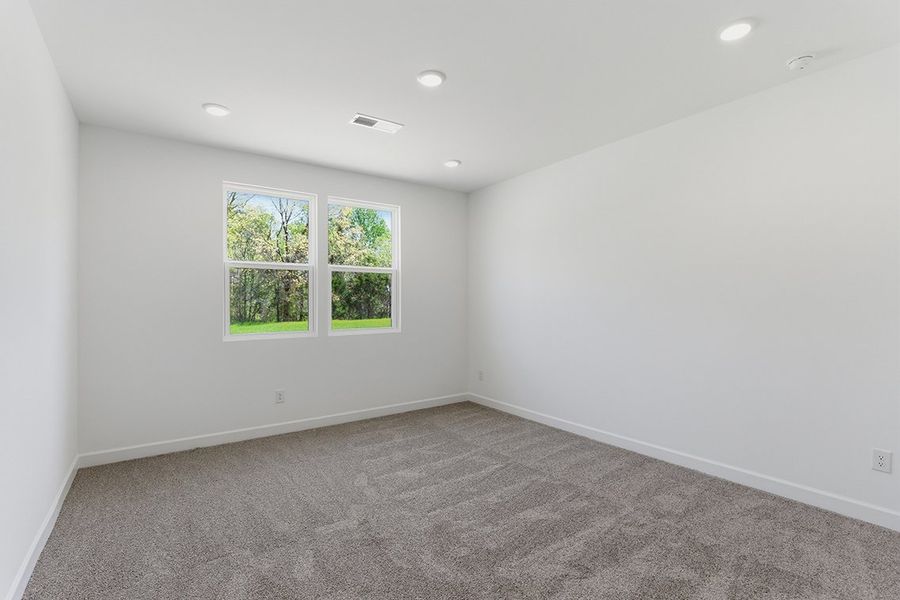 A room with a window and a carpet. A room with a window and a carpet.