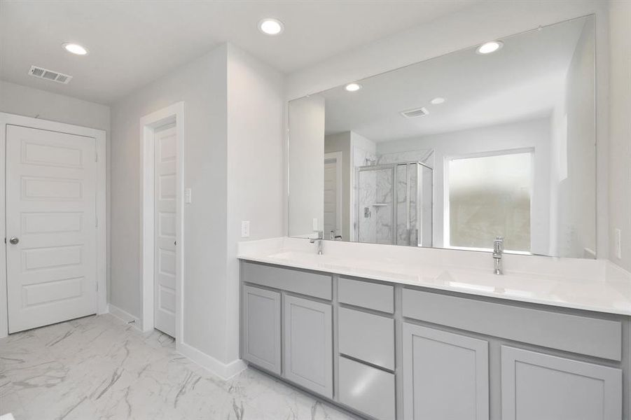 Experience luxury in this spa-like primary bathroom.  Sample photo of completed home with similar floor plan. As-built interior colors and selections may vary.