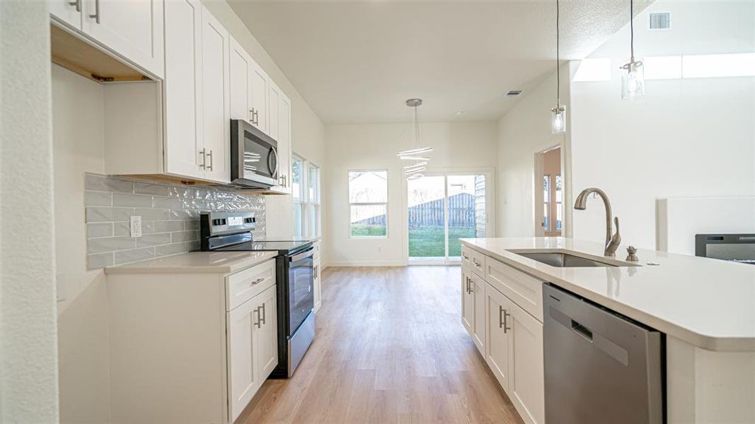 Whirlpool appliance and grey subway tile backsplash.  Open and light and bright