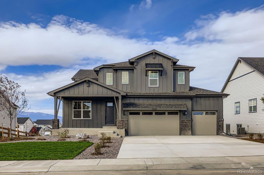 Front exterior of a new home in Timber Ridge, Colorado Springs, CO, highlighting curb appeal (Image 1).
