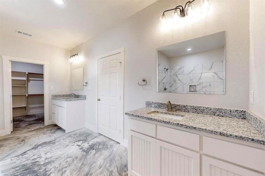 Bathroom featuring a shower and vanity