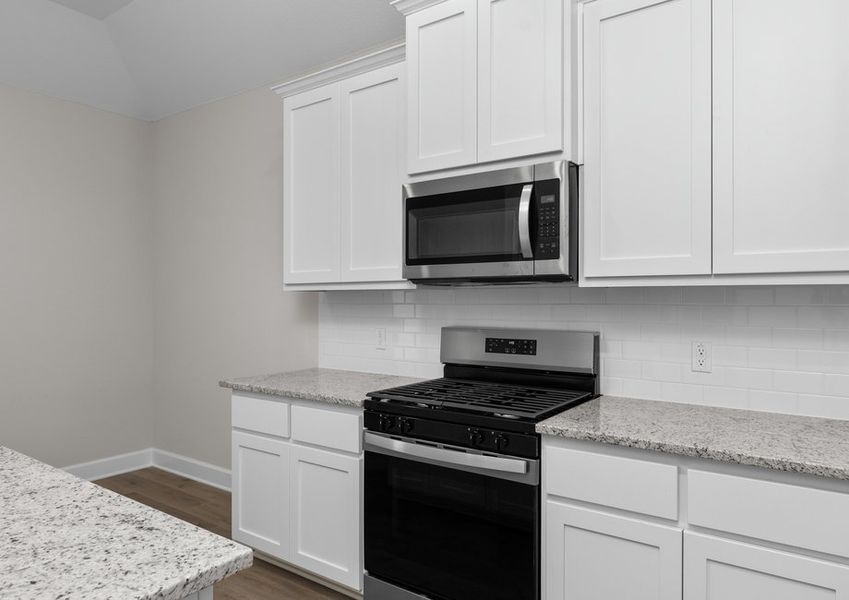 The kitchen has beautiful white wood cabinetry. The kitchen has beautiful white wood cabinetry.