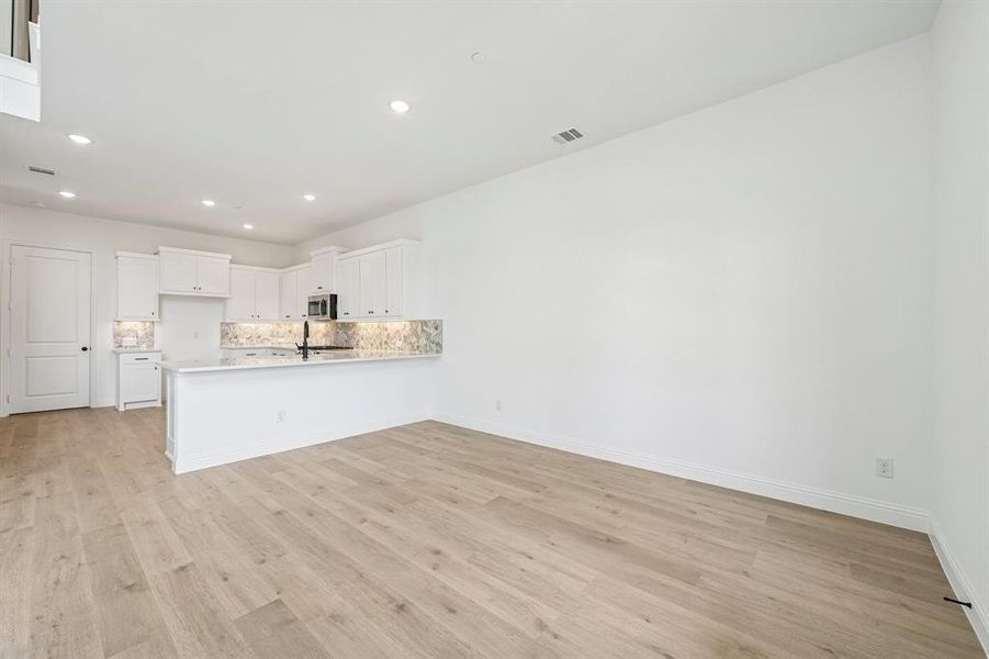 The kitchen features a spacious peninsula creating additional counter space and a breakfast bar. The kitchen features a spacious peninsula creating additional counter space and a breakfast bar.
