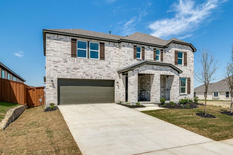 Front exterior of a new home in Heartland Signature, Heartland, TX, highlighting curb appeal (Image 1). Front exterior of a new home in Heartland Signature, Heartland, TX, highlighting curb appeal (Image 1).