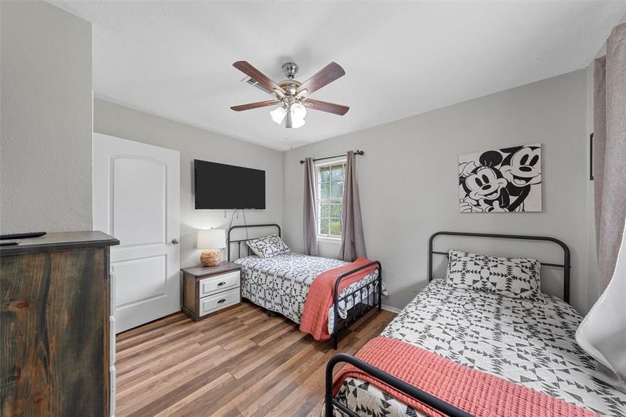 Bedroom featuring wood finished floors and a ceiling fan Bedroom featuring wood finished floors and a ceiling fan