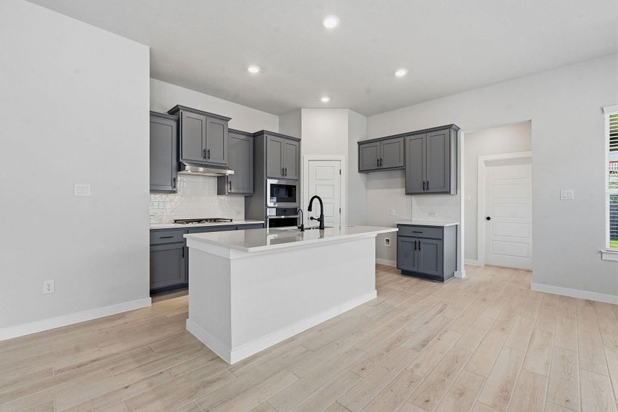A well-appointed kitchen showcasing an inviting island, ideal for culinary creations and gathering.