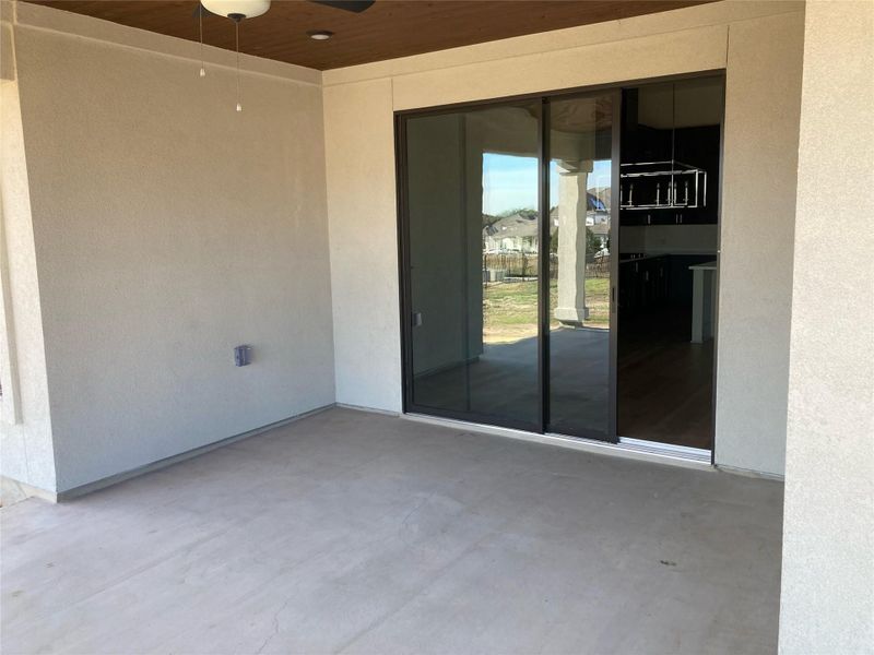 Enjoy the picturesque, Texas Hill Country views from the covered patio of this home that comes complete with a built-in outdoor kitchen and ceiling fan.