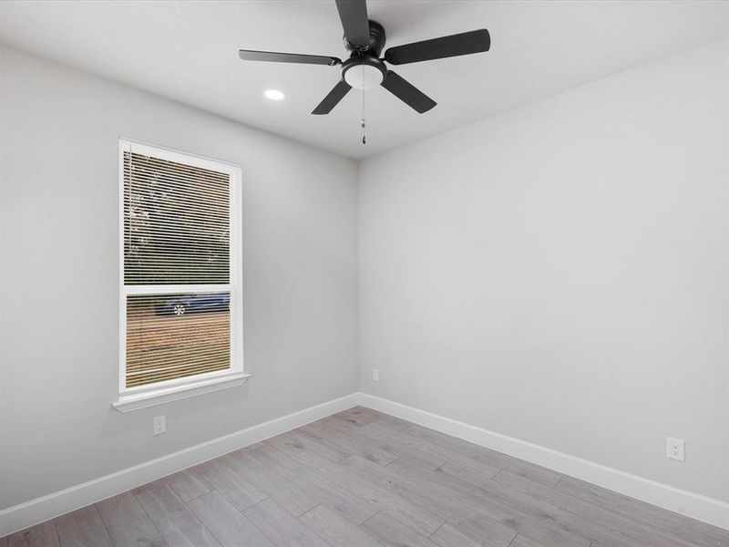 Spare room with light wood-type flooring, ceiling fan, and recessed lighting