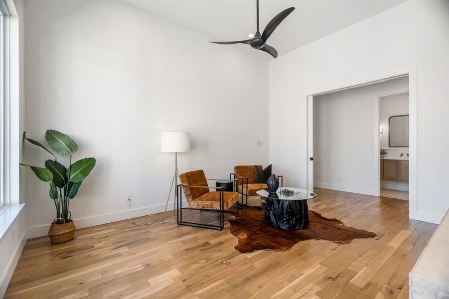 Living area featuring light hardwood / wood-style flooring and ceiling fan