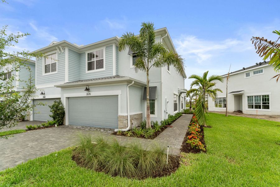Front exterior of a new home in Avila, Jensen Beach, FL, highlighting curb appeal (Image 1). Front exterior of a new home in Avila, Jensen Beach, FL, highlighting curb appeal (Image 1).