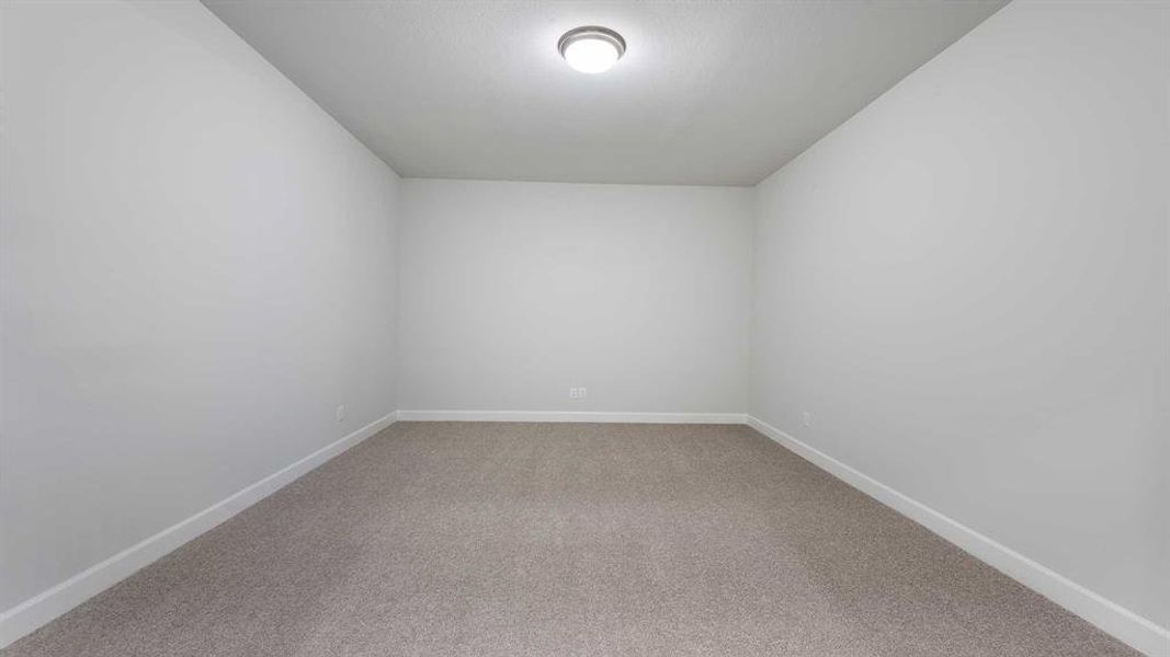 Spare room featuring carpet flooring