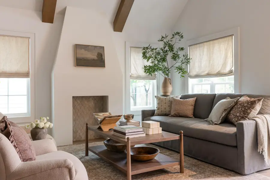 Vaulted ceiling with exposed wood beams and a custom designed decorative fireplace feature Vaulted ceiling with exposed wood beams and a custom designed decorative fireplace feature