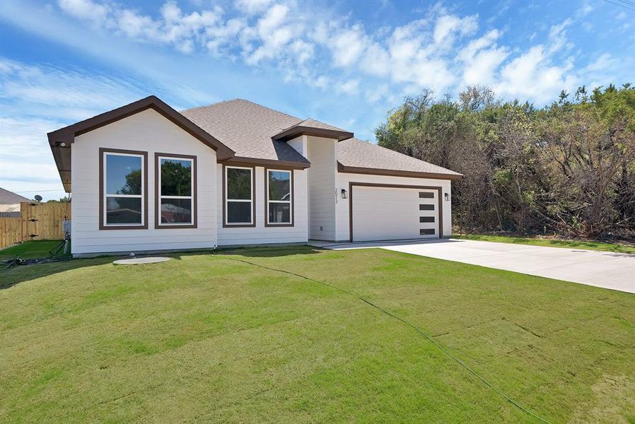 Front exterior of a new home in , Granbury, TX, highlighting curb appeal (Image 15).