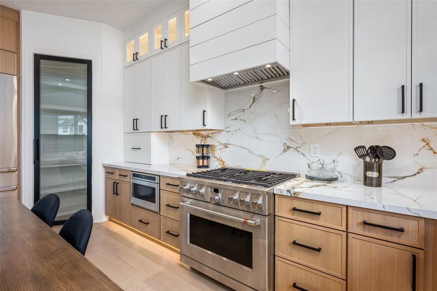 Premium six-burner GE Café range anchors the kitchen with high-performance style