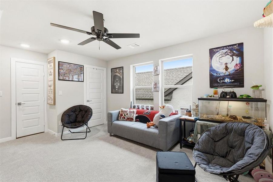 The second floor living room is spacious with a ceiling fan and closet storage space The second floor living room is spacious with a ceiling fan and closet storage space