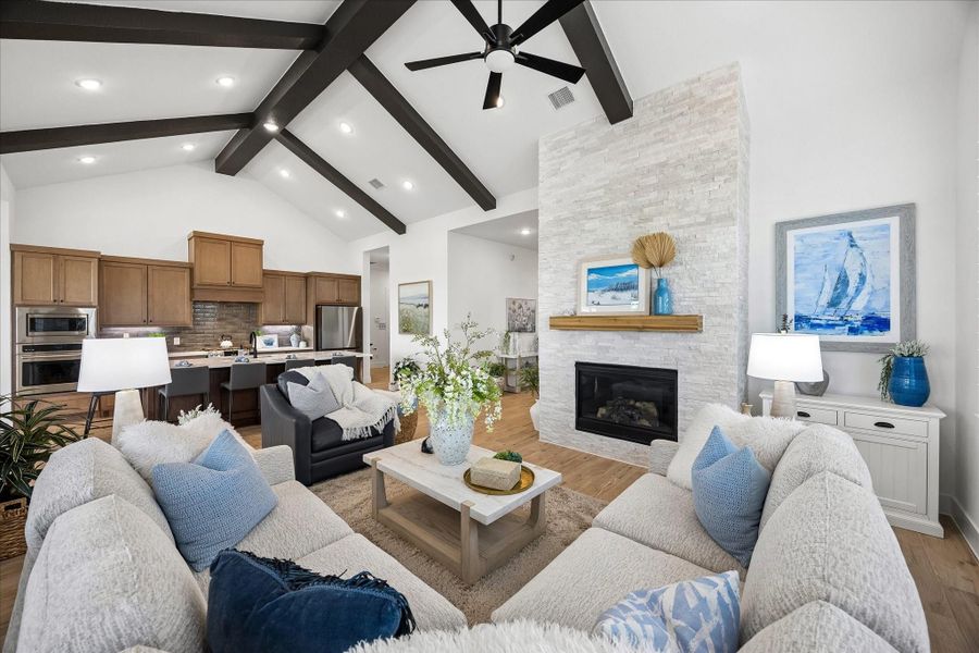 The home features an open-concept layout where views extend seamlessly from the front entry through the kitchen, creating an inviting flow and effortless connection throughout the living space.