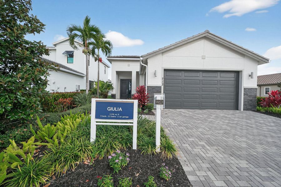 Front exterior of a new home in Tesoro Club, Port St. Lucie, FL, highlighting curb appeal (Image 1). Front exterior of a new home in Tesoro Club, Port St. Lucie, FL, highlighting curb appeal (Image 1).