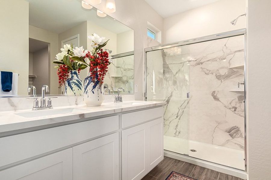 A bathroom with a glass shower. A bathroom with a glass shower.