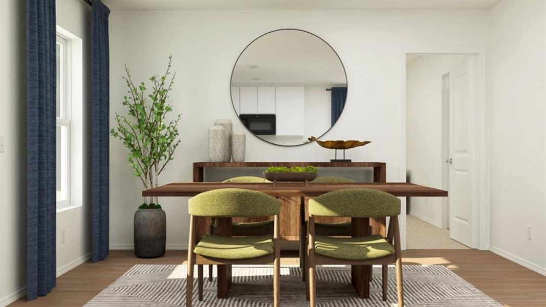 Dining space featuring light wood-style flooring and baseboards