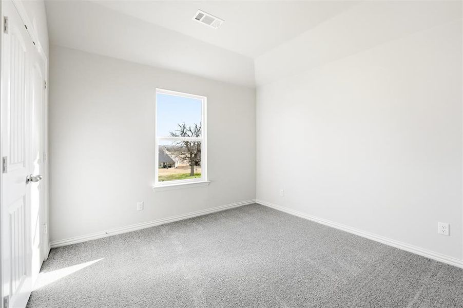Carpeted spare room with baseboards