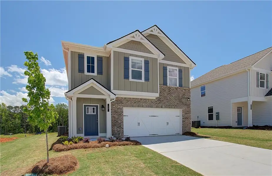 Front exterior of a new home in Enclave at Evergreen, Fairburn, GA, highlighting curb appeal (Image 2). Front exterior of a new home in Enclave at Evergreen, Fairburn, GA, highlighting curb appeal (Image 2).