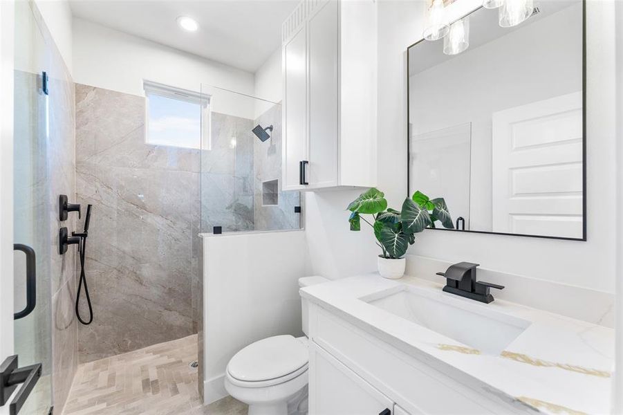 Full bathroom with a tile shower and vanity
