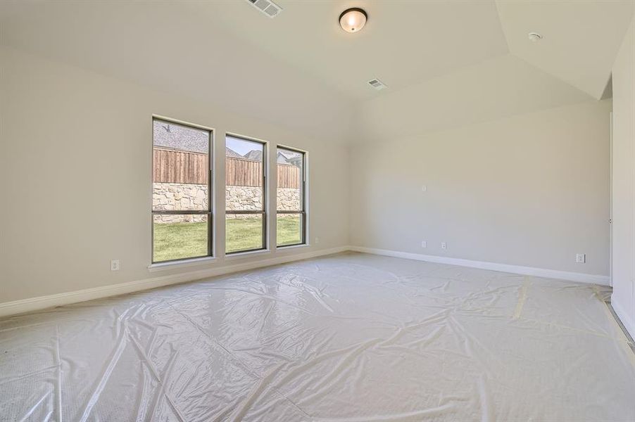 Unfurnished room featuring vaulted ceiling