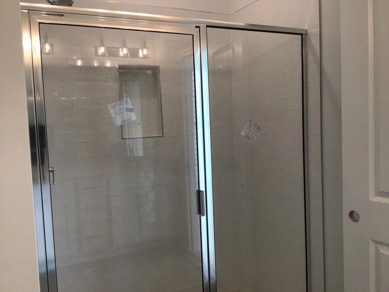 Primary Bath featuring the AW Collection® Coastal - Spa-like with white cabinets and light tile.