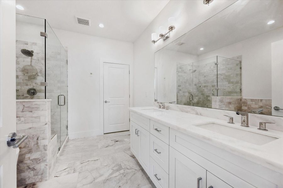 Primary Bathroom * Please Notice ALL the Marble * Soothing Colors * Dual Sinks * Marble Floors with Different Veining. Primary Bathroom * Please Notice ALL the Marble * Soothing Colors * Dual Sinks * Marble Floors with Different Veining.