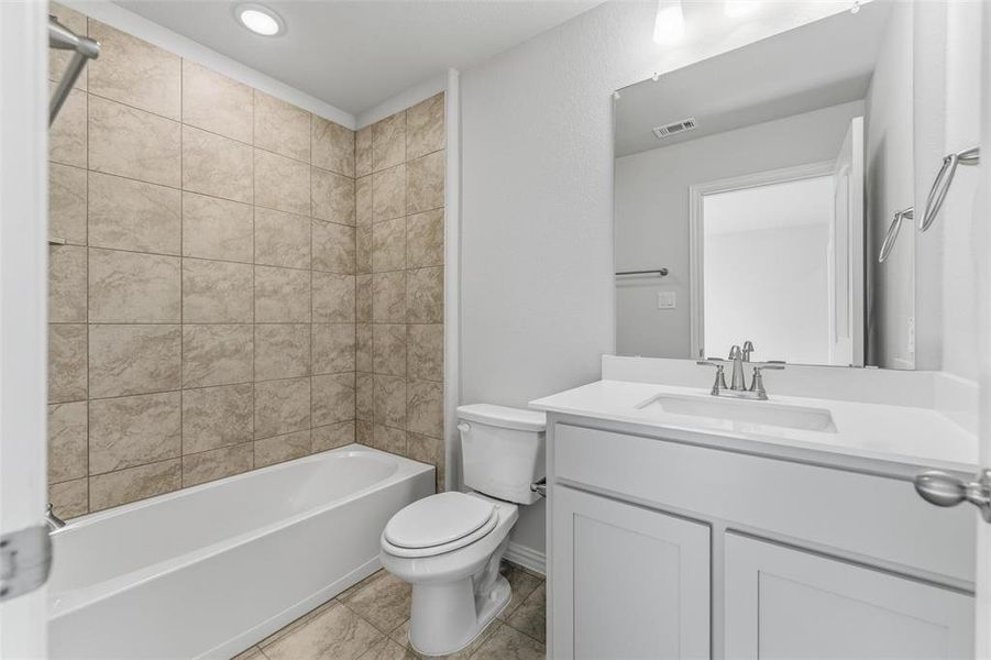 Bathroom featuring  shower combination, vanity, and recessed lighting
