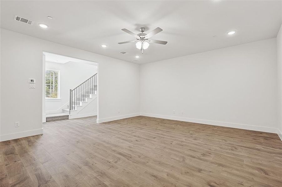 Empty room featuring ceiling fan and light hardwood / wood-style flooring