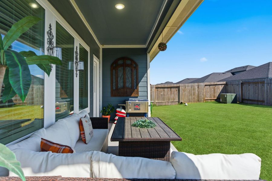 Fully fenced backyard with a covered patio—ideal for outdoor dining or weekend lounging. Fully fenced backyard with a covered patio—ideal for outdoor dining or weekend lounging.
