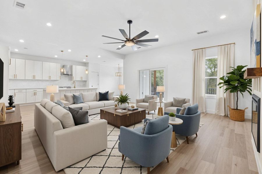 Virtually staged Living room featuring recessed lighting, light wood finished floors, and a ceiling fan