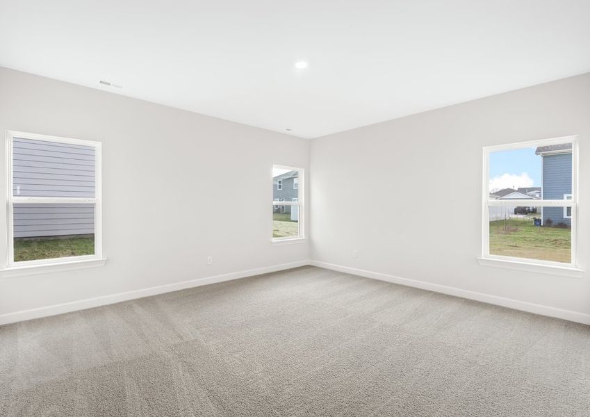 This bedroom has lots of windows