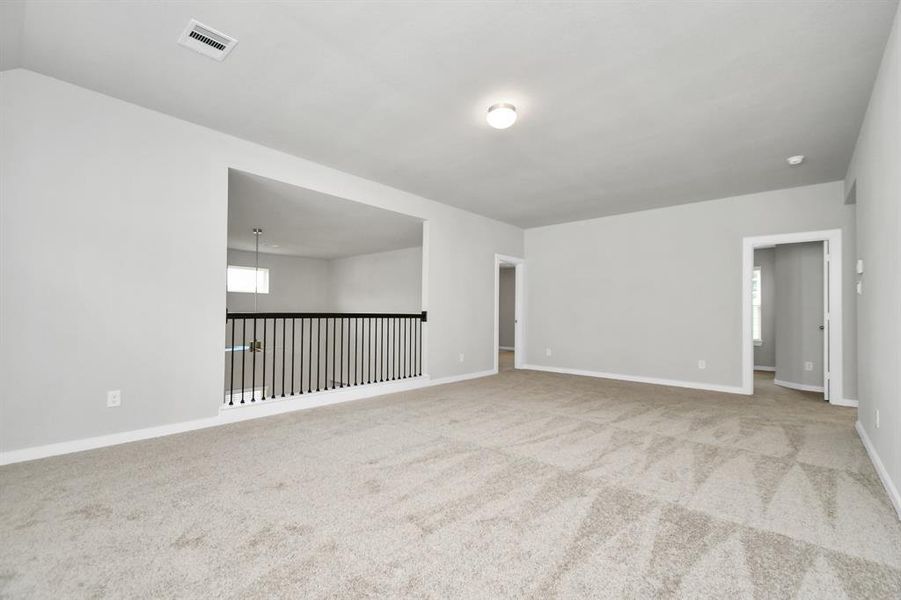 Another view of expansive game room. Sample photo of completed home with similar plan. As built color and selections may vary.