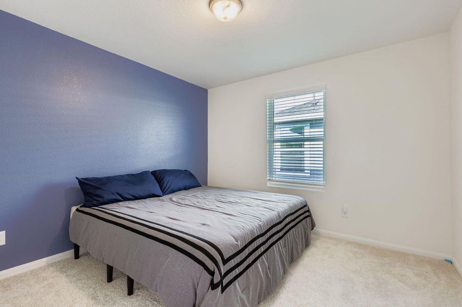 Carpeted bedroom featuring baseboards