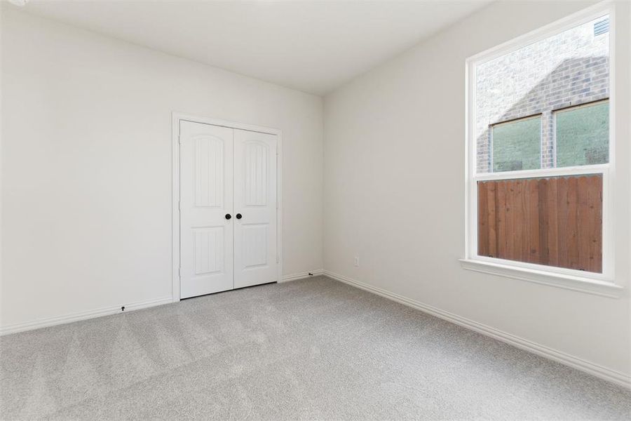 Unfurnished bedroom featuring carpet flooring and a closet