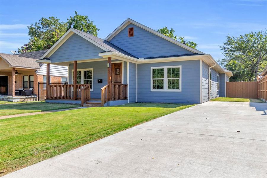 Bungalow-style house with a front lawn and a porch