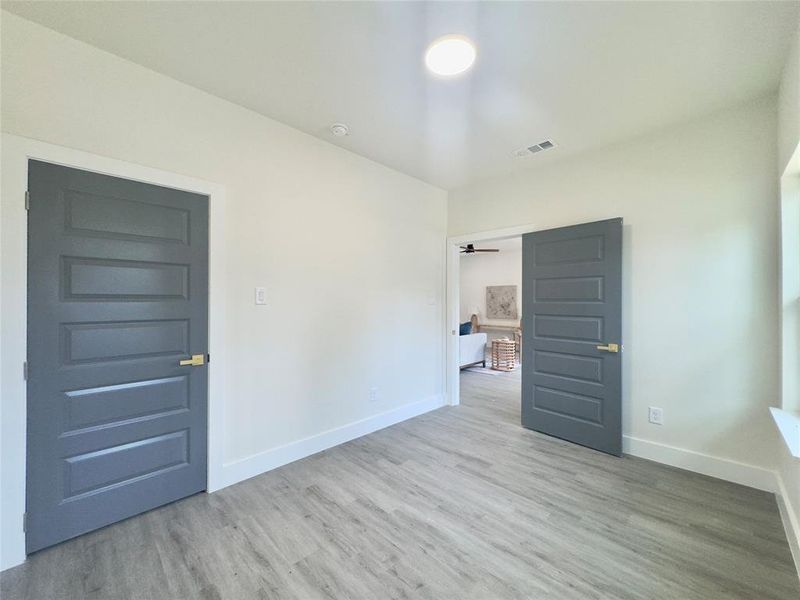 Unfurnished bedroom with a closet and light hardwood / wood-style flooring