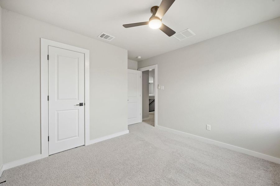 Plush carpeting and clean architectural lines define this comfortable secondary bedroom space. Plush carpeting and clean architectural lines define this comfortable secondary bedroom space.