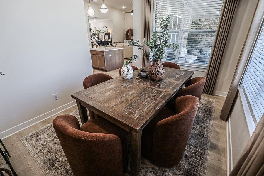 Dining room with light wood-style flooring and baseboards