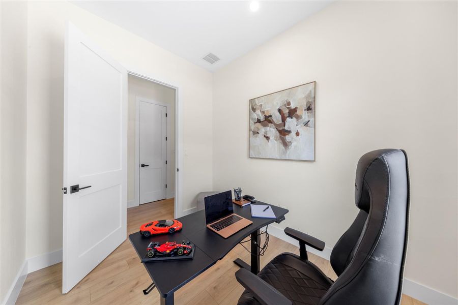 Office with baseboards and light wood-style floors Office with baseboards and light wood-style floors