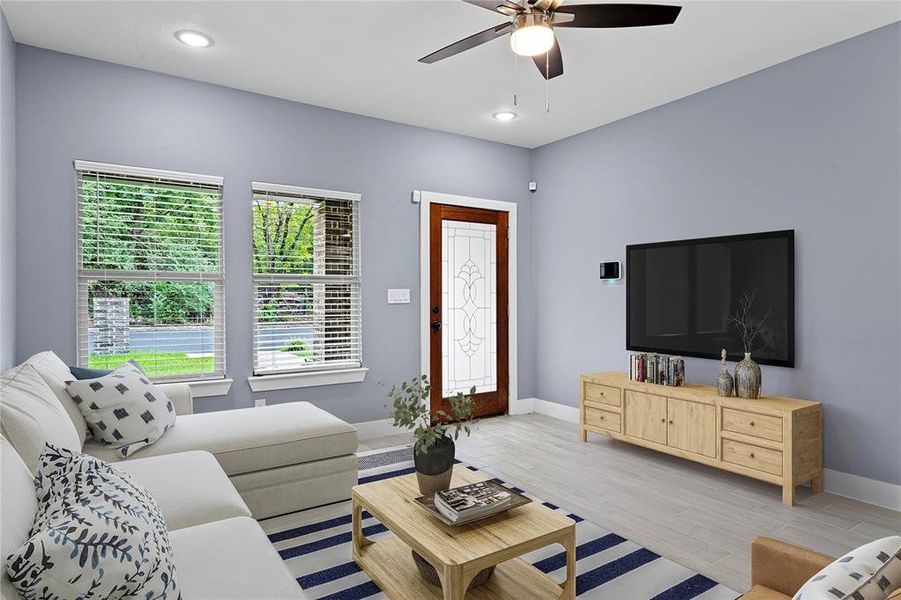 Living room featuring wood finished floors, recessed lighting, and a ceiling fan Living room featuring wood finished floors, recessed lighting, and a ceiling fan