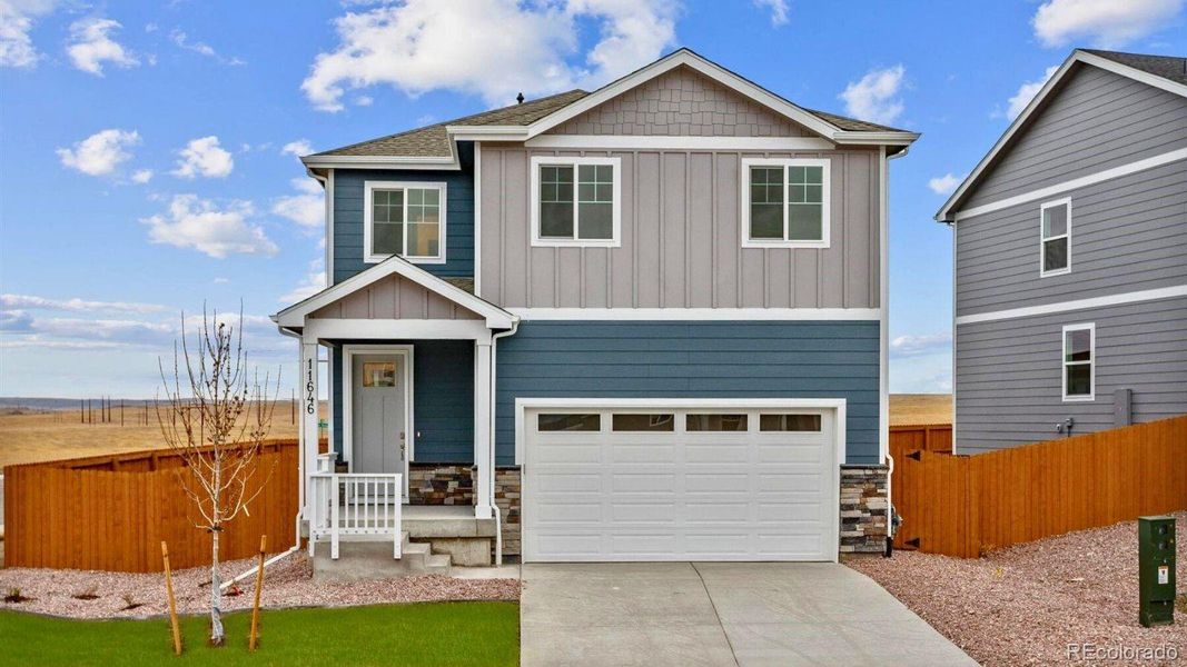 Front exterior of a new home in Silver Peaks, Lochbuie, CO, highlighting curb appeal (Image 1).